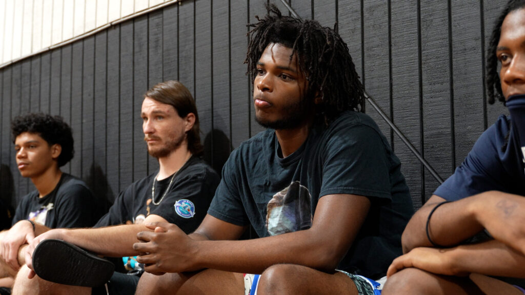 Kenny Anderson speaks to Florida Coastal Prep Academy players, who listen intently to his advice and inspiration